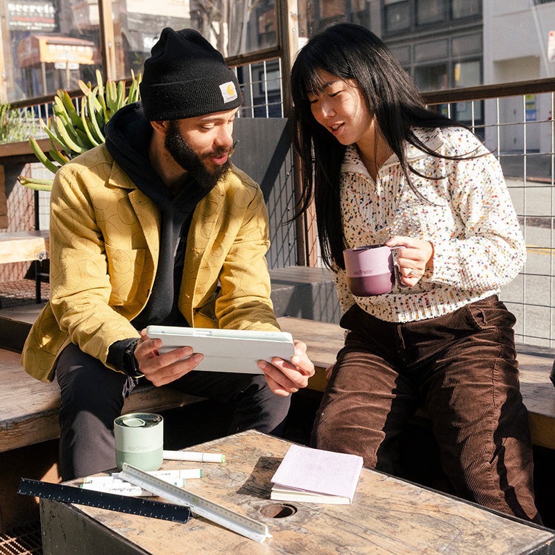 12oz-rise-mug-c8 12oz_rise_coffee_mug_dusty_orchid_couple_city_patio_square.jpg