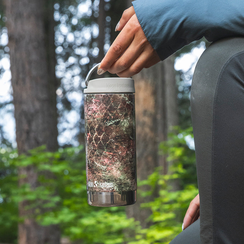 12oz-tkwide-with-cafe-cap-mossy-oak-u0 12oz_tumbler_mossyoak_rainbowtrout_hand_closeup_square.jpg
