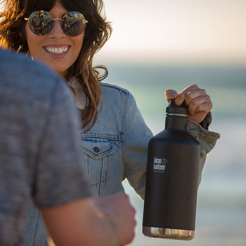 64oz-classic-with-loop-cap-b1 64oz_insulated_classic_black_beach_girl_hand_square.jpg